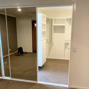 White framed, mirror doors & custom walk-in-robe shelving