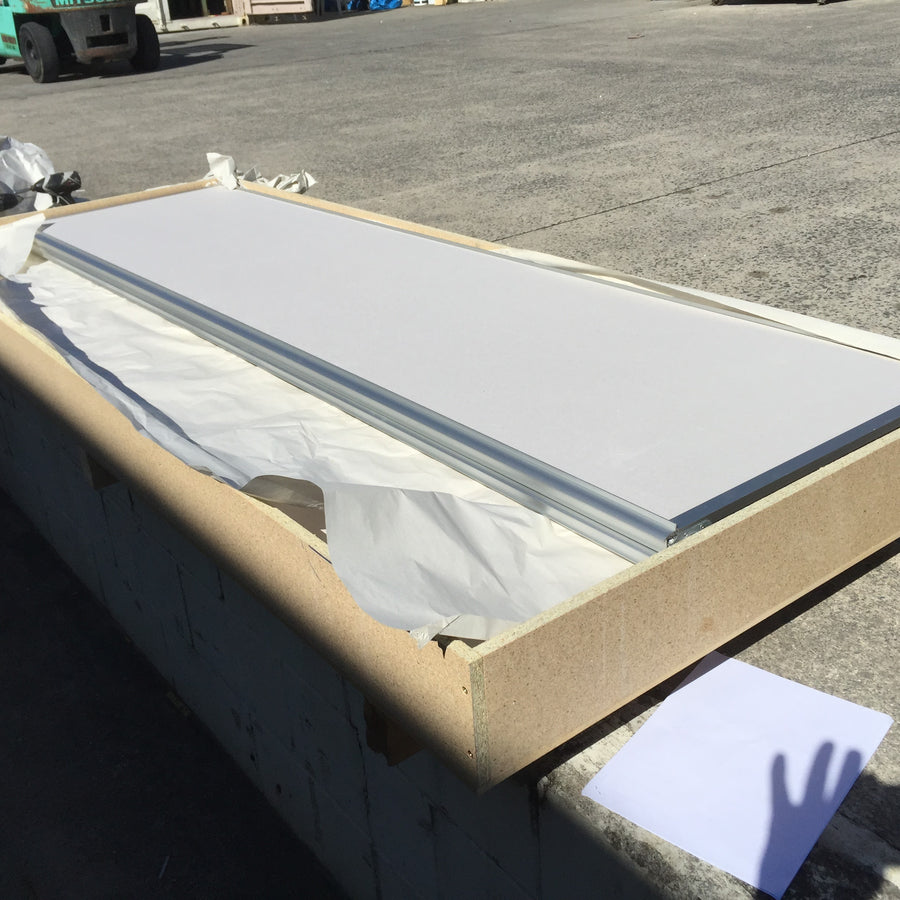 White wardrobe door protected inside an open craftwood freight frame